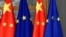 FILE - European Union and Chinese flags are displayed at the Europa building in Brussels, Dec. 17, 2019. 
