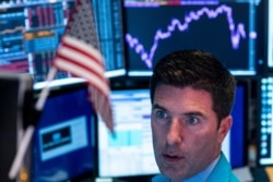 Traders work after the closing bell at the New York Stock Exchange (NYSE) on Aug. 12, 2019 at Wall Street in New York City.