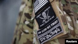 Patches on the sleeve of a militiaman are seen at the Malheur National Wildlife Refuge near Burns, Oregon, site of a takeover by self-styled militiamen who were protesting the federal government's role in governing wild lands, Jan. 4, 2016.