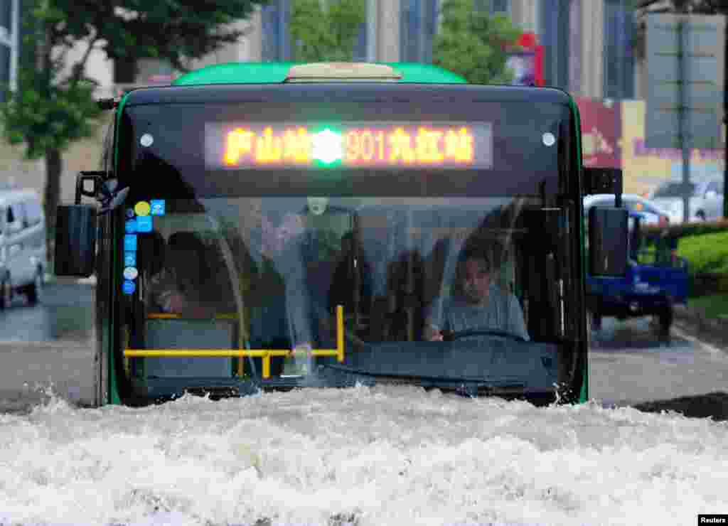 A bus goes through a flooded area in Jiujiang, Jiangxi Province, China, June 19, 2016.