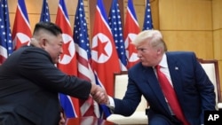 FILE - U.S. President Donald Trump and North Korean leader Kim Jong Un meet in the Demilitarized Zone, South Korea, June 30, 2019. North Korea on Friday says it wants Trump to make a "wise option and bold decision" to restart stalled nuclear diplomacy