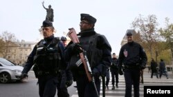 Police patrol in Place de la Republique after a series of deadly attacks the previous day in Paris, Nov. 14, 2015. 