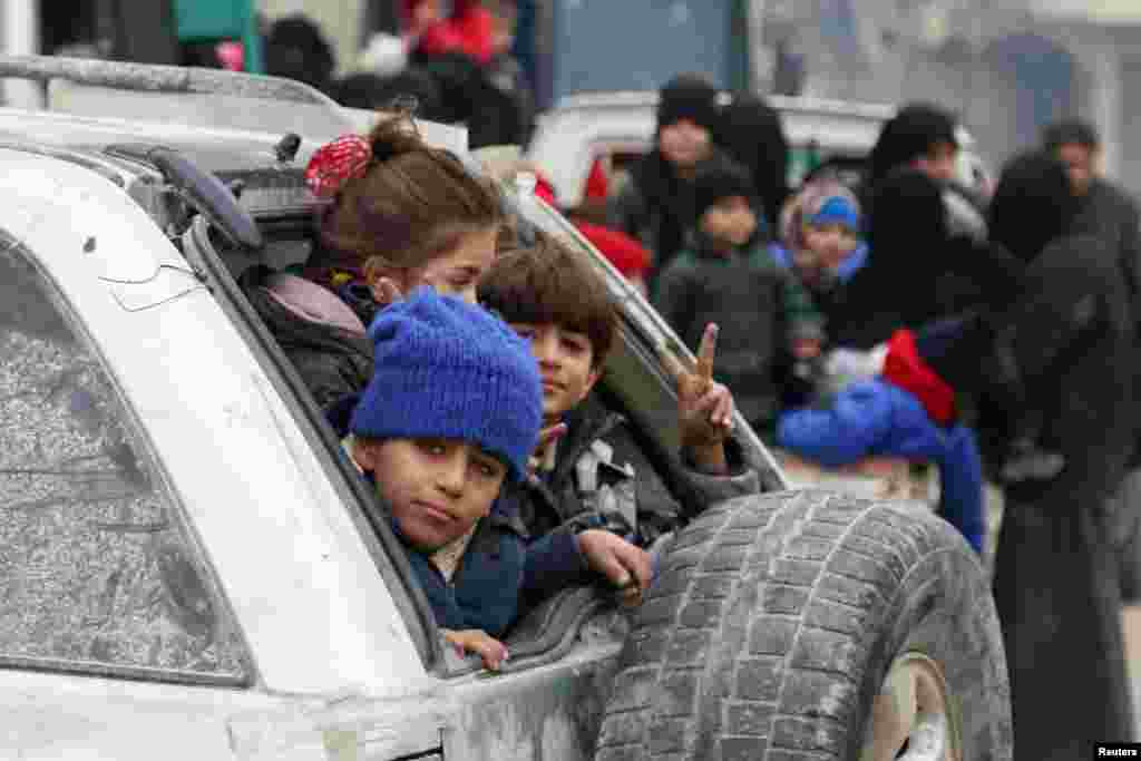 Children sit in a car as they wait to be evacuated from a rebel-held sector of eastern Aleppo, Syria Dec. 16, 2016. 