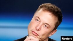 FILE - Elon Musk listens at a press conference following the first launch of a SpaceX Falcon Heavy rocket at the Kennedy Space Center in Cape Canaveral, Florida, U.S., Feb. 6, 2018. 