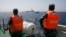 Vietnamese Marine Guard officers monitor a Chinese coast guard vessel on the South China Sea, about 210 km (130 miles) offshore of Vietnam, May 15, 2014.