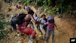 Migrantes, en su mayoría venezolanos, cruzan el Tapón del Darién desde Colombia hacia Panamá el 15 de octubre de 2022. 