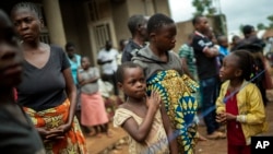 Parents and children wait to be vaccinated in Beni, Congo, July 13, 2019.