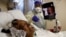 Florence Bolton, 86, a coronavirus disease (COVID-19) positive patient, lies in her intensive care bed as family members attempt to FaceTime her at Roseland Community Hospital on the South Side of Chicago, Illinois, Dec. 1, 2020. 