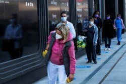 Health workers wait in line to get food near the Jacob K. Javits Convention Center, as the outbreak of the coronavirus disease (COVID-19) continues, in the Manhattan borough of New York City, New York, April 7, 2020.
