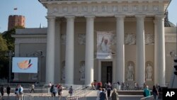 A banner with a portrait of Pope Francis is seen in front of the Cathedral Basilica of St. Stanislaus and St. Ladislaus in Vilnius, Lithuania, Sept. 21, 2018, ahead of the pontiff's upcoming visit to Lithuania, Latvia and Estonia.
