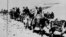 In this March 21, 1959 file photo the Dalai Lama and his escape party is shown on the fourth day of their flight to freedom as they cross the Zsagola pass, in Southern Tibet, while being pursued by Chinese military forces, after fleeing Lhasa. 