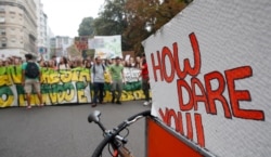 Activists demonstrate during a worldwide protest demanding action on climate change, in Milan, Italy, Sept. 27, 2019.