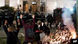 Police attempt to push back protesters outside the Kenosha County Courthouse, Aug. 24, 2020, in Kenosha, Wisconsin.