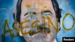 The Spanish word for "murderer" covers a mural of Nicaragua's President Daniel Ortega, May 26, 2018, as part of anti-government protests demanding his resignation in Managua, Nicaragua.