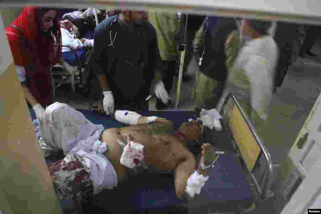 A man wounded in an explosion at a Shi'ite mosque receives treatment at a hospital in Peshawar, Feb. 13, 2015.
