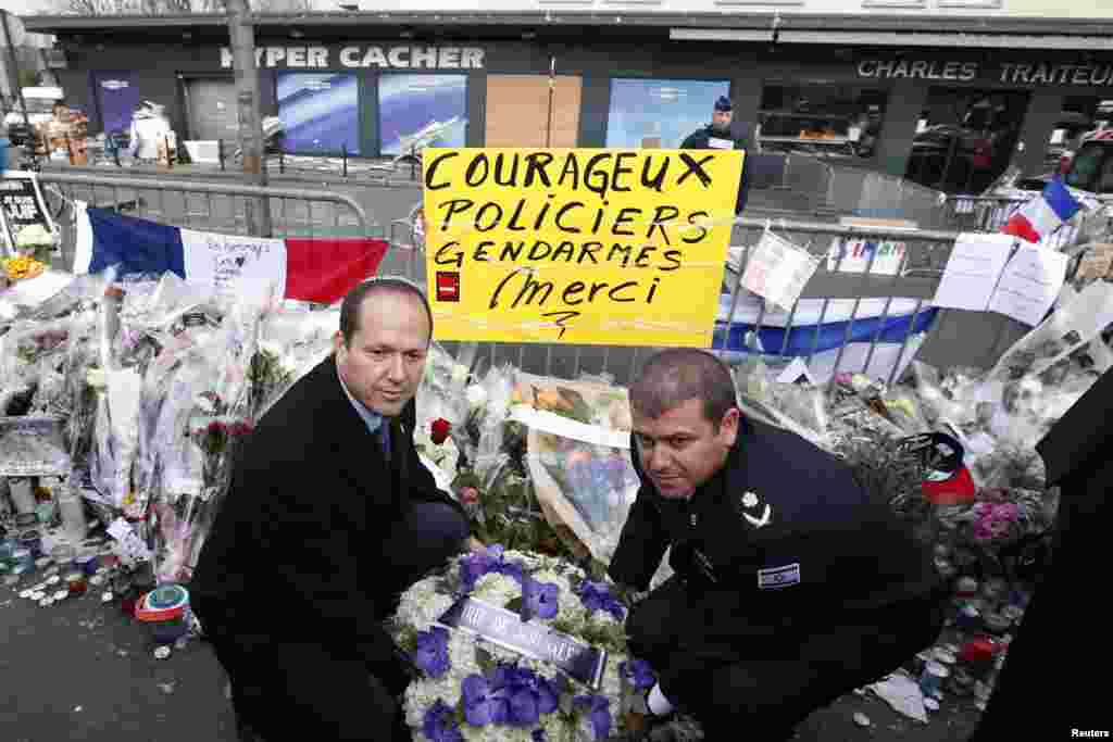 Jerusalem Mayor Nir Barkat and Jerusalem District Commander, Major General Moshe Chico Edry place flowers near the Hyper Cacher kosher supermarket at the Porte de Vincennes in Paris, Jan. 21, 2015.