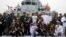 FILE - Foreign naval officers gather for a photo on the naval training ship Qi Jiguang before a parade to commemorate the 70th anniversary of the founding of China's PLA Navy April 23, 2019.