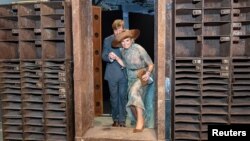 FILE - King Willem-Alexander and Queen Maxima of the Netherlands stand in the door of the former "Tresor" techno music club as they visit the "Berlin Global" exhibition at the Humboldt Forum museum and cultural center in Berlin, Germany July 7, 2021. 