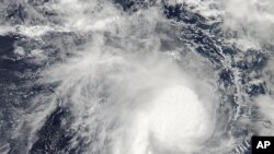 This image from NASA's Aqua satellite and made available by NASA's Goddard MODIS Rapid Response Team shows Cyclone Marcia in the Coral Sea, off the northeast coast of Australia, Feb. 18, 2015.