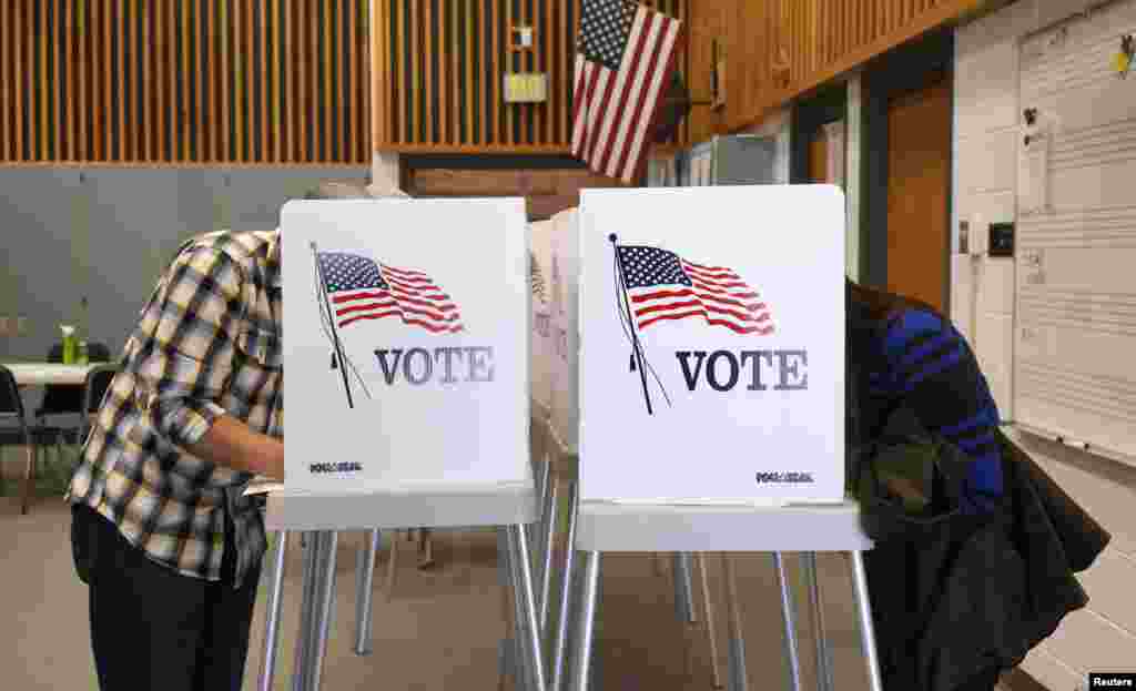 Voters fill in their ballots as they vote in the U.S. midterm elections at a polling place in Westminster, Colorado, Nov. 4, 2014.