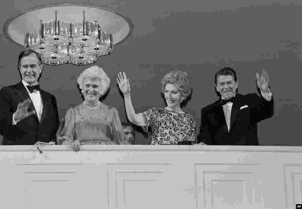 President-elect Ronald Reagan, his wife Nancy, Vice President-elect George H.W. Bush, and his wife Barbara wave from the balcony at the Kennedy Center in Washington, Jan. 19, 1981.