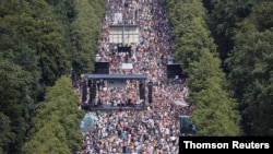 Demonstrators protest the government's restrictions amid the COVID-19 outbreak, in Berlin, Aug. 1, 2020.