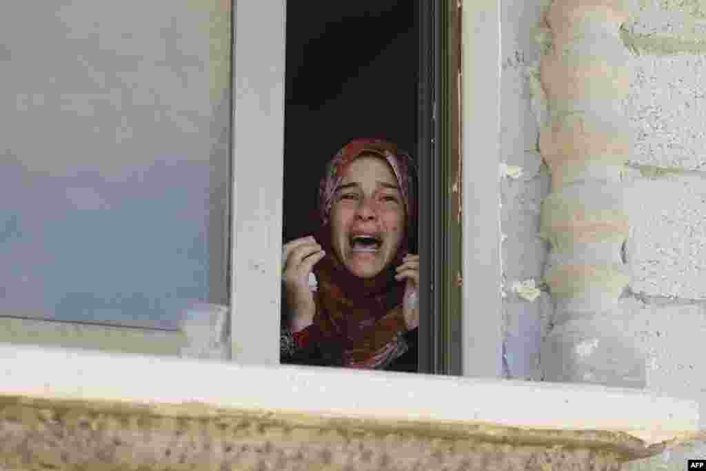 A Palestinian relative mourns during the funeral of four members of the Moamer family, including a 26-year-old militant of the Hamas movement, after they were killed in an Israeli air strike in southern Gaza Strip city of Rafah, on July 14, 2014.