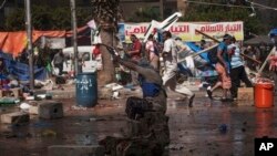 Supporter of ousted President Mohammed Morsi shoots gun toward Egyptian police, Cairo's Nasr City district, Aug. 14, 2013.