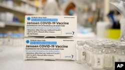 FILE - In this March 6, 2021, file photo, boxes stand next vials of Johnson & Johnson COVID-19 vaccine in the pharmacy of National Jewish Hospital for distribution in Denver. A committee of health advisors said Friday that the United States should re-start the use of the vaccine.