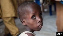 A boy suffering from severe acute malnutrition sits at one of the UNICEF nutrition clinics, in the Muna informal settlement, which houses nearly 16,000 IDPs (internally displaced people) in the outskirts of Maiduguri capital of Borno State, northeastern N