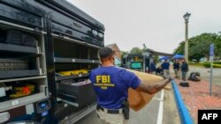 This handout photo released Dec. 7, 2019, by the Federal Bureau of Investigation (FBI) shows a member of an FBI Evidence Response Team after a shooting incident at Pensacola Naval Base, in Florida, Dec. 6, 2019.