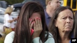 A young girl reacts at a church where students were taken to be reunited with parents following a school shooting in Marysville, Washington, Oct. 24, 2014.