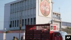 A truck leaves a Coca-Cola factory to distribute its bevarages to shops and restaurants in Phnom Penh, file photo. 