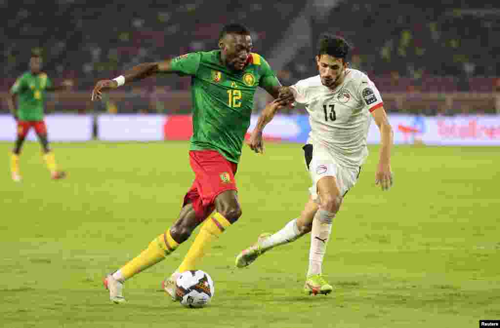 Cameroon's Karl Toko-Ekambi in action with Egypt's Ahmed Fatouh, Feb. 3, 2022.