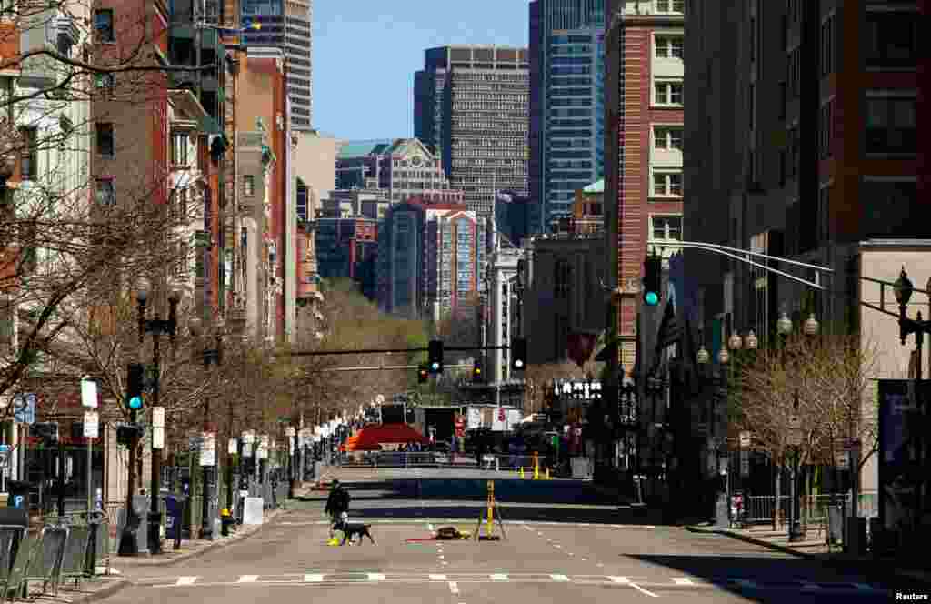 An investigator walks near the site of the bombings in Boston, April 21, 2013.