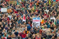 Demonstrators hold up posters at a climate change rally in Erfurt, Germany, Sept. 27, 2019.