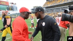 FILE - Tampa Bay Buccaneers head coach Lovie Smith, left, and Pittsburgh Steelers head coach Mike Tomlin shake hands following a game on Sept. 28, 2014, in Pittsburgh. There are currently two Black head coaches in the 32-team NFL.