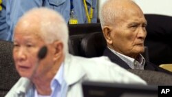 In this photo released by the Extraordinary Chambers in the Courts of Cambodia, Khieu Samphan, left, former Khmer Rouge head of state, and Nuon Chea, right, who was the Khmer Rouge's chief ideologist and No. 2 leader, sit in the court hall before they made closing statements at the U.N.-backed war crimes tribunal in Phnom Penh, file photo. 