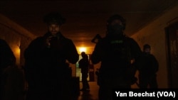 Ukrainian soldiers take shelter on a military post a few kilometers from the front line in eastern Ukraine, Feb. 19, 2022, in Novoluganske, Ukraine. (Yan Boechat/VOA)