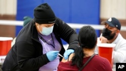 A Pfizer COVID-19 vaccine is administered at a recreation center in Wilmington, California, April 13, 2021.