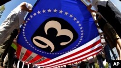 FILE - Visitors to the Flight 93 National Memorial in Shanksville, Pa., participate in a sunset memorial service on Sept. 10, 2019.