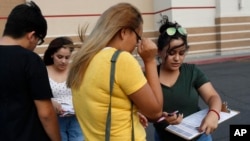 FILE - Activists Maria Nieto, right, and Alma Romo, second from left, register people to vote in the U.S. midterm election in November, in Las Vegas, Neveda, Aug. 15, 2018.