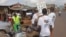 Health workers speak to people on the streets to educate them about the deadly Ebola virus in the city of Freetown, Sierra Leone, Aug. 4, 2014.