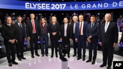 Candidates in France's presidential race pose for a group photo prior to a television debate at French private TV channels BFM TV and CNews, in La Plaine-Saint-Denis, outside Paris, April 4, 2017. 