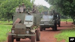 FILE - Ugandan troops patrol Zemio, in Central African Republic, where they are hunting down the fugitive members of the Lord's Resistance Army rebel group. 