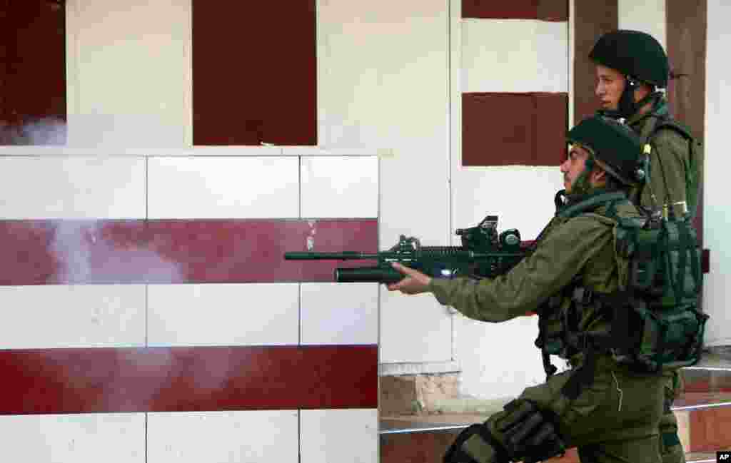 Israeli army soldiers fire tear gas during clashes with Palestinians in an operation in the West Bank city of Jenin, July 2, 2014.