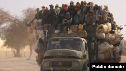U.S. President Barack Obama speaks toward Myanmar opposition leader Aung San Suu Kyi, left, during a roundtable with members of parliament and civil society to discuss Myanmar's reform process in Naypyitaw, Nov. 13, 2014.