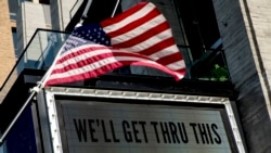 In this April 6, 2020 photo, a sign at The Anthem music venue reads "We'll Get Thru This" at the wharf which is almost completely empty because of the coronavirus outbreak in Washington.