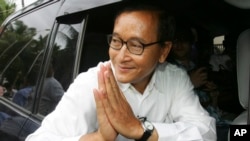 FILE - In this July 27, 2008 photo, Sam Rainsy leader of Sam Rainsy Party greets his supporters after casting his vote at a polling station in kampong Cham province north of Phnom Penh.