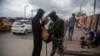 Tentara India tampak mengecek isi tas dari seorang pria Kashmir yang berjalan melewati area pasar yang sibuk di Srinagar pada 11 Oktober 2021. (Foto: AP/Mukhtar Khan)